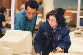 Photograph of two students at a computer station