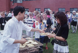 Photograph of Kim Moritsugu serving at a barbeque