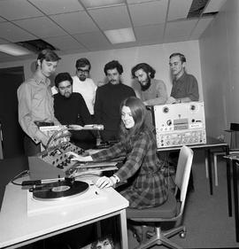 Photograph of a student practising queuing an LP record in the campus radio station