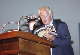 Photograph of D.M. Thomas at the podium