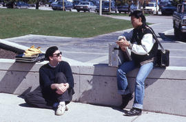 Photograph of students talking by the walkway to the NX building