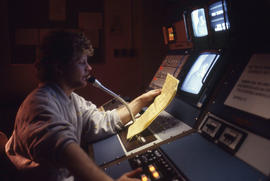 Photograph of a student directing a recording session at a video console in IMC