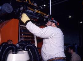 Photograph of a student working on an equipment