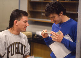 Photograph of two students looking at circuit cards