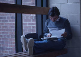 Photograph of student reading some documents