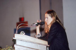 Photograph of Ann Beattie standing at the podium