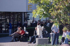 Photograph of students milling about outside E building