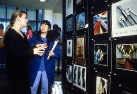 Photograph of two people having a discussion about the art on display