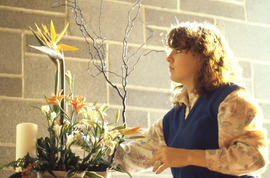 Photograph of a student completing work on a floral arrangement