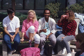 Photograph of students seated on patio benches