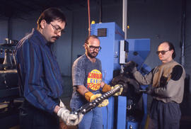 Photograph of an instructor explaining a piece of equipment to students