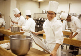 Photograph of student chefs preparing tools and ingredients for a recipe
