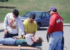 Photograph of student paramedics tending to a victim in a mock scenario