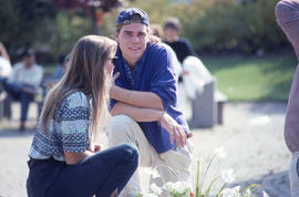 Photograph of Two Students Talking on the Patio