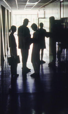 Photograph of students gathered in the hall at their lockers in building "E"