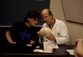 Photograph of an Instructor With a Student Studying Anatomy
