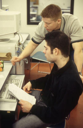 Photograph of two students working on drafting assignments