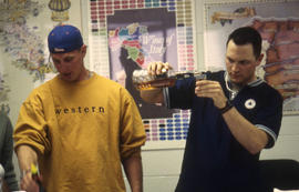 A photograph of students in the Bartending lab pouring drinks