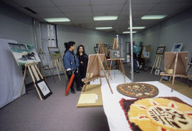 Photograph of People Viewing Art Pieces at the Student Art Competition