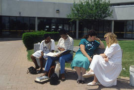 Photograph of people sitting on a bench