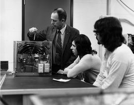 Photograph of Barry Conroad Explaining to Two Students How an Air Conditioning System Operates