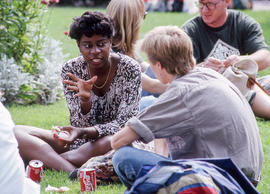 Photograph of students seated on the lawn on campus