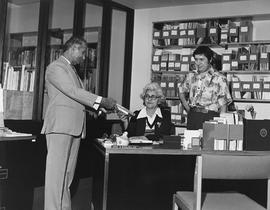 Photograph of Fred Balsara Giving Audrey MacLellan Books in the Library