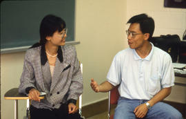 Photograph of Two Students Talking in Class