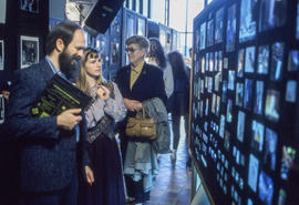 Photograph of visitors reviewing students photograph display