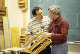 Photograph of two persons in discussion in the Cabinet Making / Woodworking Lab