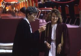 Photograph of a Registrar office member speaking with a graduate