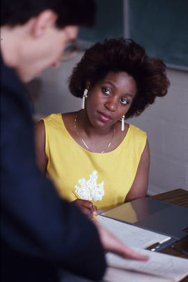 Photograph of a student assisted by an instructor