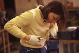 Photograph of a student working with a vise tool
