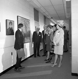 Photograph of visitors viewing Creative Arts displays in a D building hallway