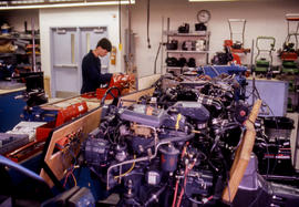 Photograph of students working in a small engines repair lab