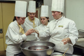 Photograph of students preparing food to serve in the Humber Room