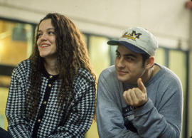 Photograph of two students watching a performance