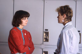 Photograph of students in conversation by the lockers