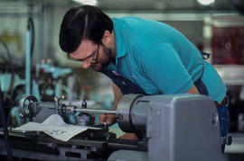 Photograph of a Student Working With a Metal Lathe