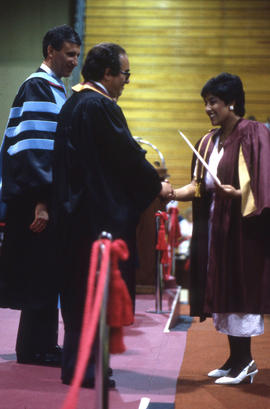 Photograph of a Graduate receiving a Diploma