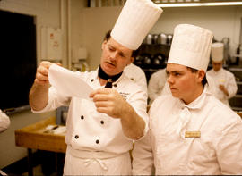 Photograph of Chef Michael McFadden demonstrating folding paper for piping