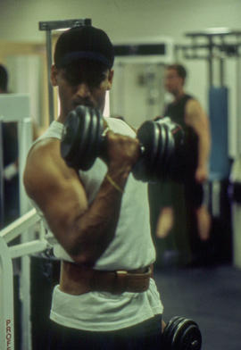 A photograph of a student in the Athletic Centre doing a bicep curl