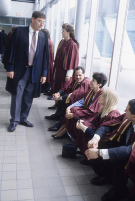 Photograph of an Instructor Talking to Graduates
