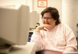 Photograph of a woman sitting at a computer