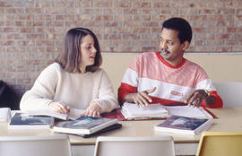 Photograph of students working on homework in the Lakeshore cafeteria