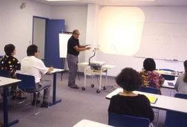 Photograph of an Instructor Lecturing in a Classroom