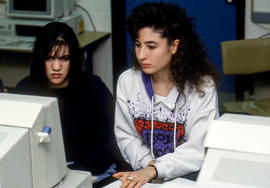Photograph of two students working at a computer together