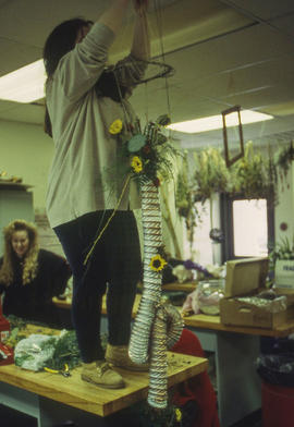 A photograph of a student hanging their floral arrangement