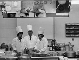 Photograph of Igor Sukor Working with Students at a Demonstration Table