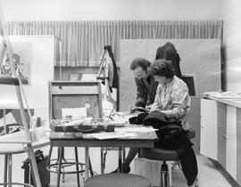 Photograph of Edward Thibodeau Helping his Painting Student